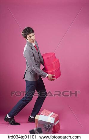 A man with the gift boxes dropping from his hands View Large Photo Image Stock Image - A man with the gift boxes dropping from his hands . Fotosearch