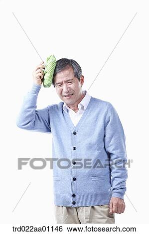 Stock Photograph - A painful elderly man with headache . Fotosearch
