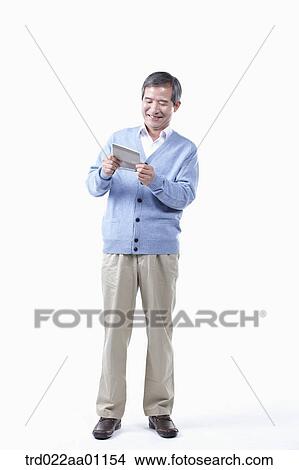A smiling elderly man looking at the bankbook View Large Photo Image Picture - A smiling elderly man looking at the bankbook. Fotosearch