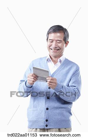 A smiling elderly man looking at the bankbook View Large Photo Image Stock Image - A smiling elderly man looking at the bankbook. Fotosearch
