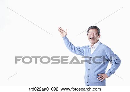 A smiling elderly man with his hand up to the sky View Large Photo Image Stock Image - A smiling elderly man with his hand up to the sky . Fotosearch