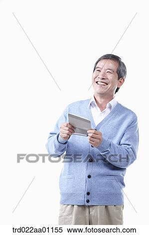 Stock Photography - A smiling elderly man with the bankbook. Fotosearch