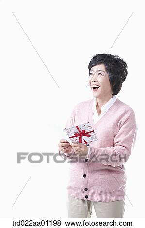 A smiling elderly woman with a card View Large Photo Image Stock Photo - A smiling elderly woman with a card. Fotosearch