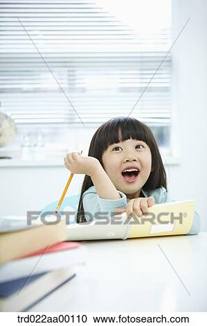 A smiling girl holding a notebook and pencil View Large Photo Image Stock Image - A smiling girl holding a notebook and pencil . Fotosearch