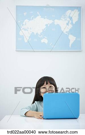 A smiling girl with a laptop on the desk View Large Photo Image Stock Image - A smiling girl with a laptop on the desk. Fotosearch