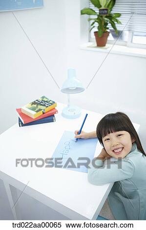 A smiling girl writing 'Happy' on the blue paper with a blue colored pencil View Large Photo Image Stock Photography - A smiling girl writing 'Happy' on the blue paper with a blue colored pencil. Fotosearch