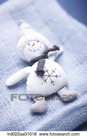 Stock Photo - A snowman on a blue knit muffler . Fotosearch