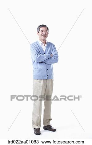 A standing elderly man with his arms folded View Large Photo Image Stock Image - A standing elderly man with his arms folded. Fotosearch