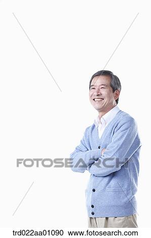 A standing elderly man with his arms folded View Large Photo Image Stock Image - A standing elderly man with his arms folded. Fotosearch