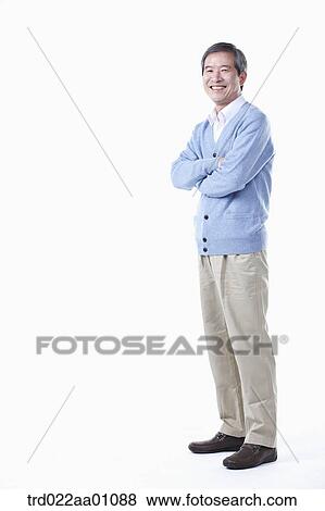 Stock Photo - A standing elderly man with his arms folded. Fotosearch