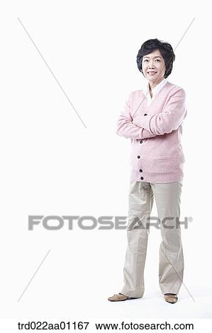 Stock Photo - A standing elderly woman with her arms folded. Fotosearch