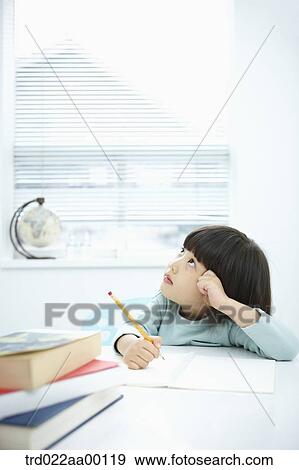 A thinking girl while holding a pencil over a note book View Large Photo Image Stock Photo - A thinking girl while holding a pencil over a note book. Fotosearch