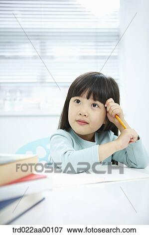 A thinking girl with a pencil in her hands View Large Photo Image Stock Photo - A thinking girl with a pencil in her hands . Fotosearch