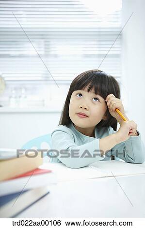 Stock Photograph - A thinking girl with a pencil in her hands . Fotosearch
