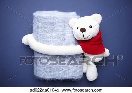 A white teddy bear putting arms around a blue knit muffler View Large Photo Image Stock Photography - A white teddy bear putting arms around a blue knit muffler . Fotosearch