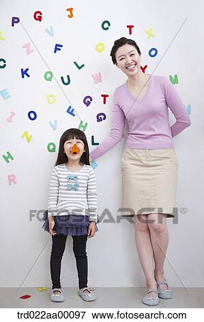 A woman and girl with alphabet blocks on the wall View Large Photo Image Stock Photo - A woman and girl with alphabet blocks on the wall. Fotosearch