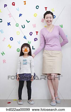 A woman and girl with alphabet blocks on the wall View Large Photo Image Stock Photo - A woman and girl with alphabet blocks on the wall. Fotosearch
