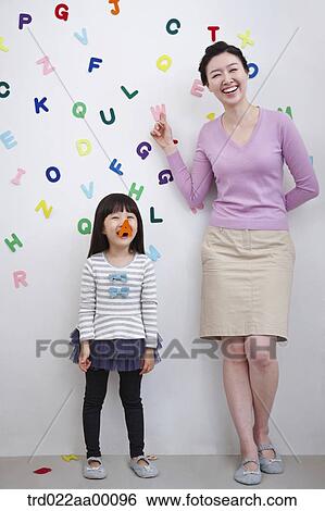 A woman and girl with alphabet blocks on the wall View Large Photo Image Stock Photograph - A woman and girl with alphabet blocks on the wall. Fotosearch