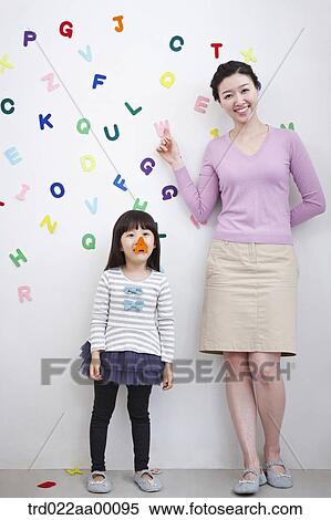 A woman and girl with alphabet blocks on the wall View Large Photo Image Stock Photography - A woman and girl with alphabet blocks on the wall. Fotosearch