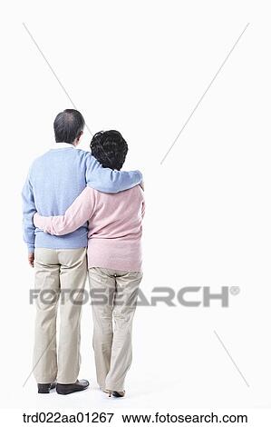 An elderly man and woman having arms around each other from behind View Large Photo Image Stock Photo - An elderly man and woman having arms around each other from behind. Fotosearch