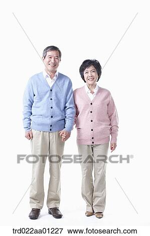 An elderly man and woman holding hands together View Large Photo Image Stock Photo - An elderly man and woman holding hands together. Fotosearch