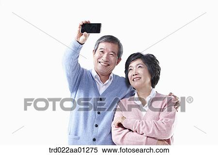 An elderly man and woman photographing together View Large Photo Image Stock Photography - An elderly man and woman photographing together. Fotosearch