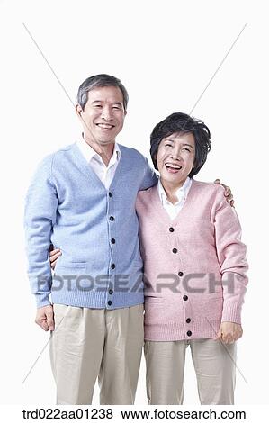 An elderly man and woman putting arms around on each other View Large Photo Image Stock Photo - An elderly man and woman putting arms around on each other . Fotosearch