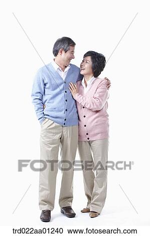 Stock Image - An elderly man and woman smiling at each other . Fotosearch