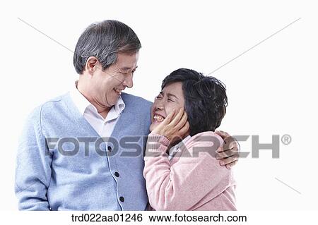 An elderly man and woman smiling at each other View Large Photo Image Stock Photograph - An elderly man and woman smiling at each other . Fotosearch