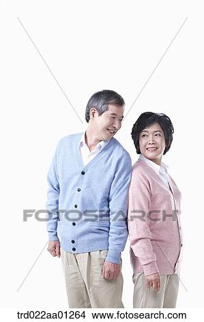 An elderly man and woman standing against each other View Large Photo Image Picture - An elderly man and woman standing against each other. Fotosearch