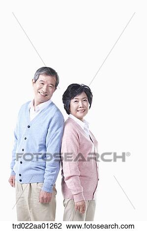 Stock Image - An elderly man and woman standing against each other. Fotosearch