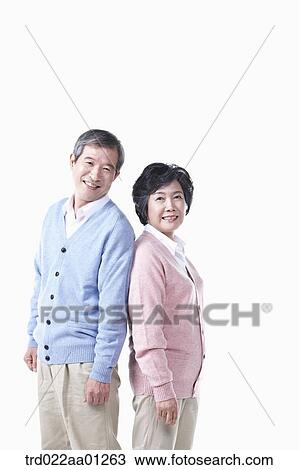 An elderly man and woman standing against each other View Large Photo Image Stock Image - An elderly man and woman standing against each other. Fotosearch