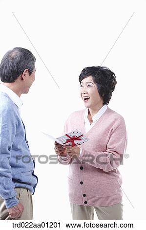 An elderly man and woman with a card View Large Photo Image Stock Image - An elderly man and woman with a card. Fotosearch