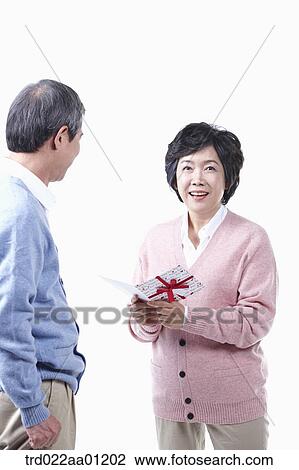 An elderly man and woman with a card View Large Photo Image Stock Image - An elderly man and woman with a card. Fotosearch