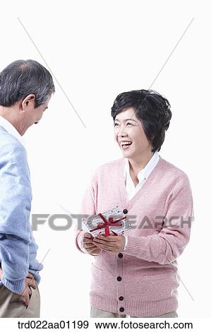 An elderly man and woman with a card View Large Photo Image Stock Photo - An elderly man and woman with a card. Fotosearch