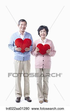 An elderly man and woman with the red heart View Large Photo Image Stock Image - An elderly man and woman with the red heart. Fotosearch