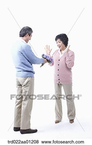 An elderly man giving a bouquet of flower for an elderly woman View Large Photo Image Stock Photo - An elderly man giving a bouquet of flower for an elderly woman . Fotosearch