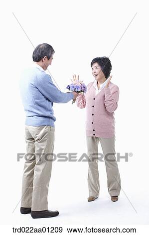 An elderly man giving a bouquet of flower for an elderly woman View Large Photo Image Stock Photo - An elderly man giving a bouquet of flower for an elderly woman . Fotosearch