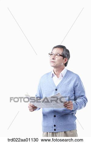An elderly man looking at the sky with a newspaper in glasses View Large Photo Image Stock Image - An elderly man looking at the sky with a newspaper in glasses. Fotosearch