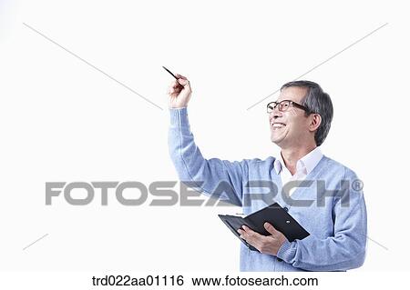 An elderly man pointing to the air with a pen in glasses View Large Photo Image Stock Photograph - An elderly man pointing to the air with a pen in glasses. Fotosearch