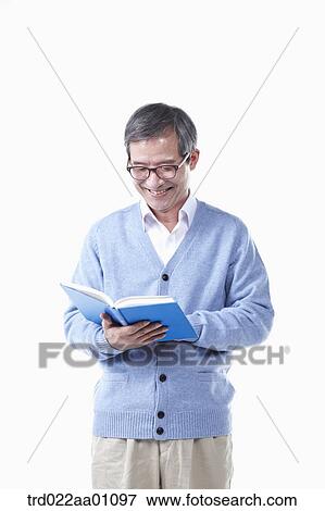 An elderly man reading a book in glasses View Large Photo Image Stock Photo - An elderly man reading a book in glasses. Fotosearch
