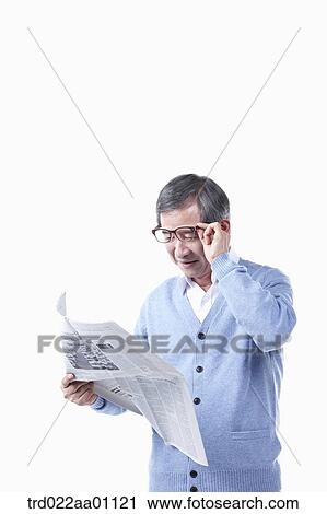 An elderly man reading a newspaper in glasses View Large Photo Image Stock Image - An elderly man reading a newspaper in glasses. Fotosearch