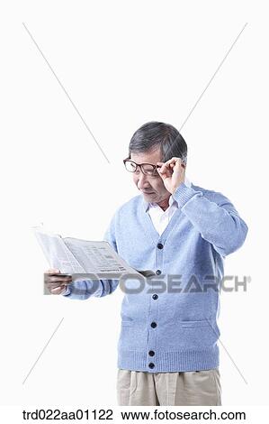 An elderly man reading a newspaper in glasses View Large Photo Image Stock Image - An elderly man reading a newspaper in glasses. Fotosearch