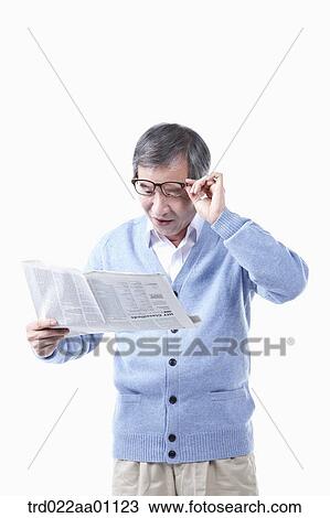 An elderly man reading a newspaper in glasses View Large Photo Image Stock Image - An elderly man reading a newspaper in glasses. Fotosearch
