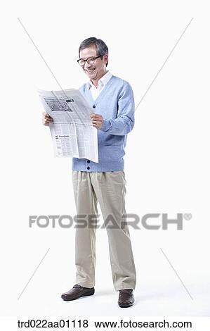 Stock Photo - An elderly man reading a newspaper in glasses. Fotosearch