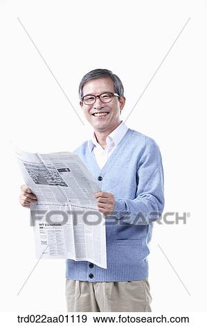 An elderly man reading a newspaper in glasses View Large Photo Image Stock Photo - An elderly man reading a newspaper in glasses. Fotosearch