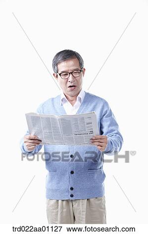An elderly man reading a newspaper in glasses View Large Photo Image Stock Photo - An elderly man reading a newspaper in glasses. Fotosearch