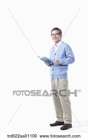 An elderly man wearing glasses with a book View Large Photo Image Stock Image - An elderly man wearing glasses with a book. Fotosearch
