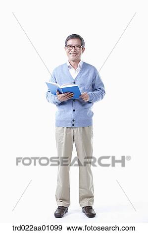 An elderly man wearing glasses with a book View Large Photo Image Stock Photo - An elderly man wearing glasses with a book. Fotosearch