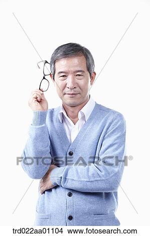 An elderly man with the glasses on his head View Large Photo Image Picture - An elderly man with the glasses on his head . Fotosearch
